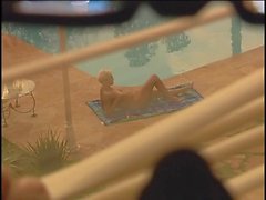 Woman sunning naked by pool is voyeured
