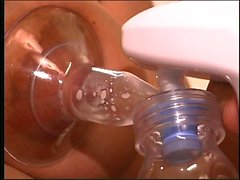 Busty dark nippled brunette uses breast pump to make milk flow from her nips