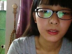 Nerdy young cock-lover takes her top off and teases the cam